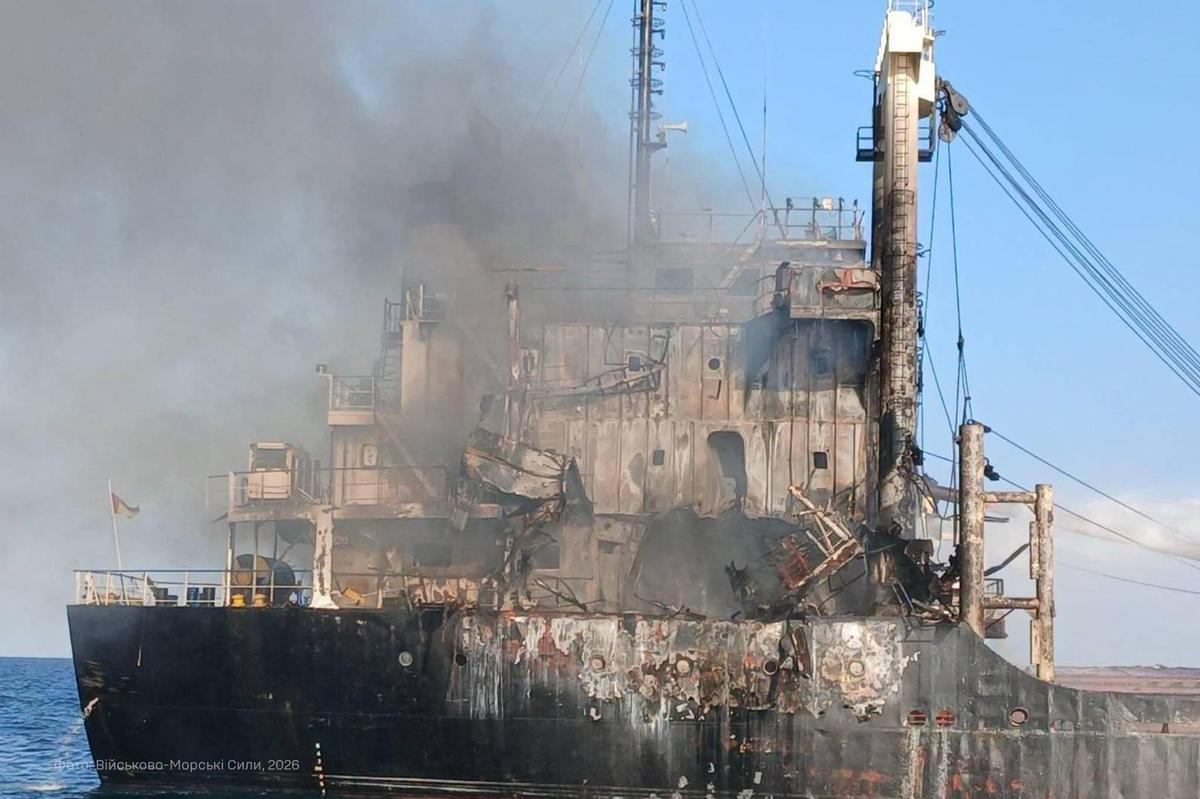 A cargo tanker on fire in the Black Sea with rescue vessels nearby.