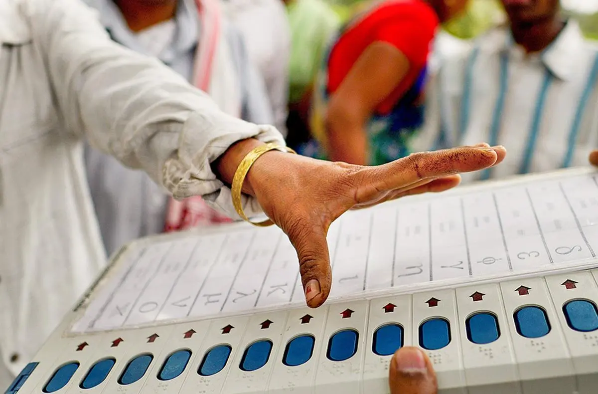 An editorial illustration of ballot boxes and three state assembly buildings representing bypolls in Bihar, Madhya Pradesh, and Gujarat.