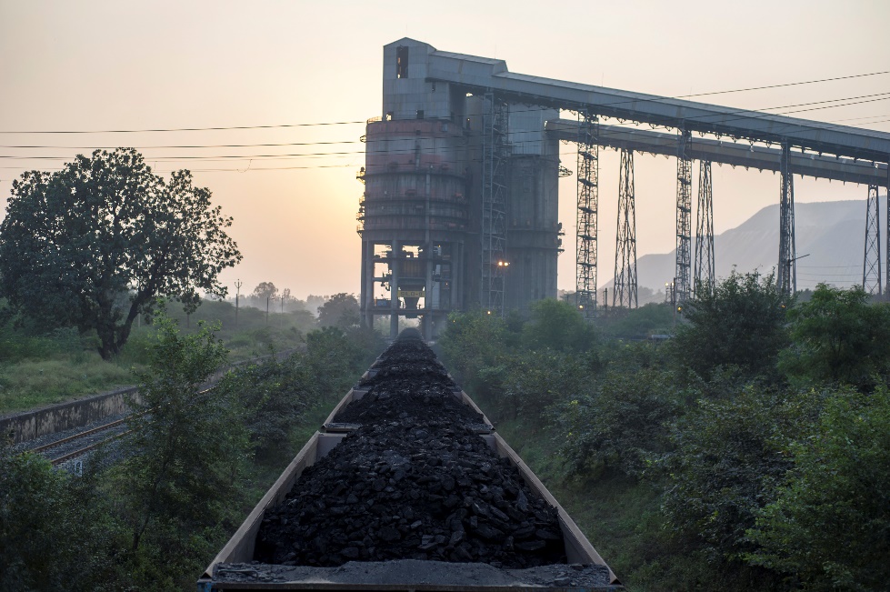 Coal loading conveyor and railway wagons at a mine-side logistics facility