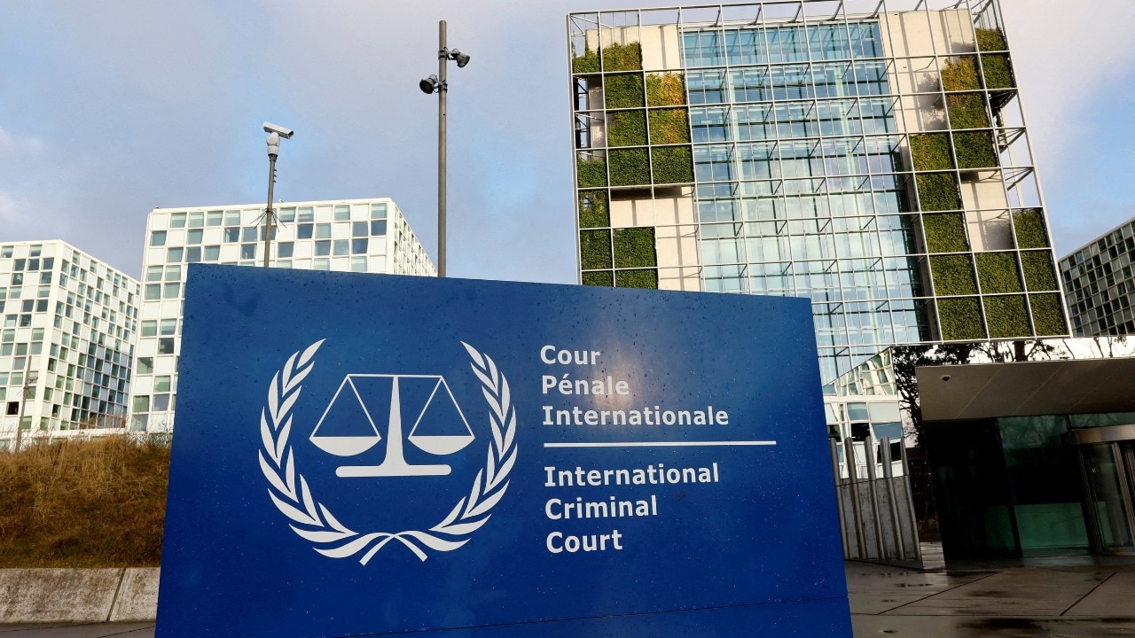 Editorial illustration of a courthouse building with a gavel and a diplomatic passport placed on a desk
