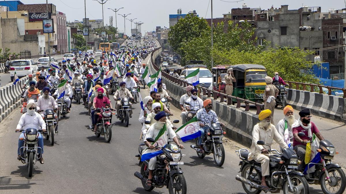 Empty inter-state border barricade with tractors and police barricades near a highway corridor