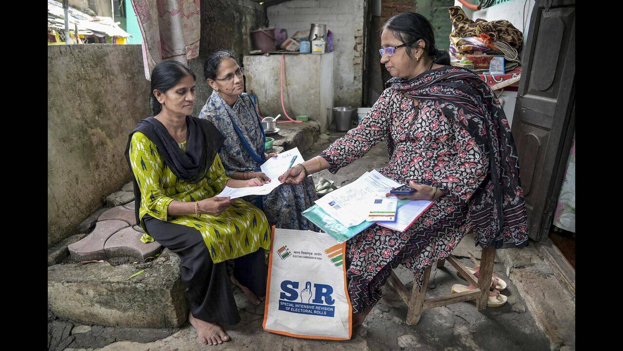 Booth Level Officer verification of voter rolls in Delhi during special intensive revision.